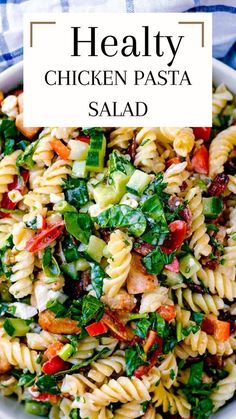 a bowl filled with pasta salad on top of a blue and white checkered table cloth