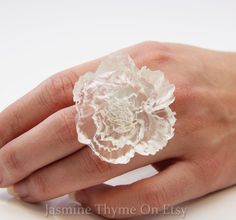 Big Statement Ring, Resin Flower Ring, Flower Ring, Rose Ring, Big White Ring, Flower Jewelry, Statement Jewelry, Resin Ring, Bridesmaid Jewelry This ring is pure glam and not someone who wants to fade into the woodwork, but if you like to make a statement it is for you! You chose the color! The flower is two inches across. If you would like the matching bangle show in the last picture please click the link below. https://www.etsy.com/ca/listing/480778248/flower-bracelet-cuff-bracelet-white?ref= Big Statement Rings, Ring Resin, Ring Flower, Special Necklace, Jewelry Resin, Rose Ring, Satin Flowers, Statement Ring Silver, Jewelry Statement