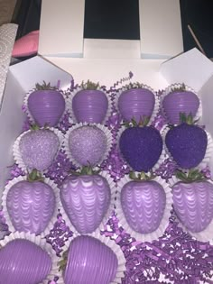 a box filled with purple chocolate covered strawberries