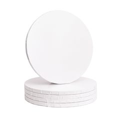 four white plates stacked on top of each other in front of a white wall background