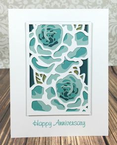 a card with blue flowers on it and the words happy anniversary written in green ink