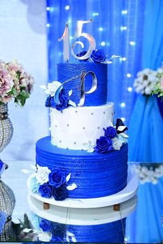 a blue and white wedding cake with flowers