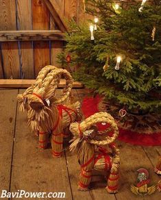 three baskets made out of straw sitting on top of a wooden floor next to a christmas tree