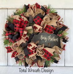 a christmas wreath with moose, pine cones and burlocks on the front door