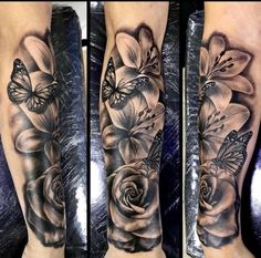 a woman's leg with flowers and butterflies on it, both in black and white