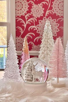 White and pink bottle brush trees and snow globe.