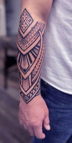 a man's arm with a tattoo on it that has an intricate design in the middle