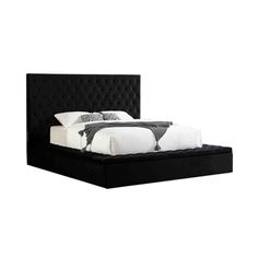 a bed with black headboard and foot board on top of the bed is shown