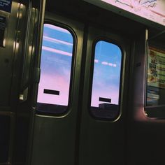 two windows on the side of a subway car