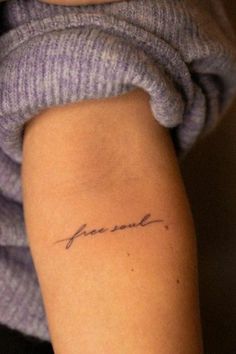 a woman's arm with a tattoo that reads, love is in the air