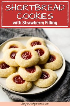 shortbread cookies with strawberry filling on a white plate and text overlay reads shortbread cookies with strawberry filling