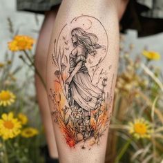 a woman's leg with a tattoo on it and flowers in the foreground