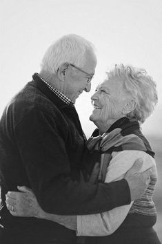 an older couple embracing each other in black and white