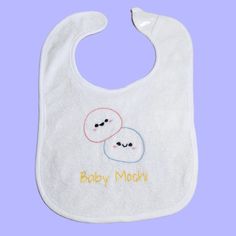 All details, from the adorable mochi's to the lettering, were hand embroidered by me on to a soft white, terry cloth baby bib with a Velcro closure. If you would like a different color for the lettering, please leave a note in the Personalization Box. Be as specific as possible. For example, instead of "blue" put "baby blue" or "navy blue". The back of the design is covered with Tender Touch fuse to protect the stitching and provide comfort for your baby. It looks like a mesh like material. Please do not remove it! You will still be able to hand wash or machine wash the bib like normal. Your Purchase Includes: - Baby Mochi Baby Bib - Care Instructions  - Cute Stickers ^-^ Playful White Machine Washable Bib, Cute White Bib For Playtime, Cute Handmade White Bib, Cute White Handmade Bib, White Machine Washable Bib For Gift, White Machine Washable Bib As A Gift, White Machine Washable Bib As Gift, Parent Gifts, New Parents