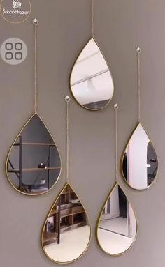 three tear shaped mirrors hanging on a wall