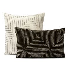 two black and white pillows sitting next to each other