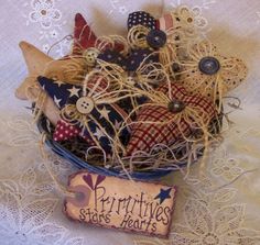 a basket filled with lots of different items on top of a lace doily covered table