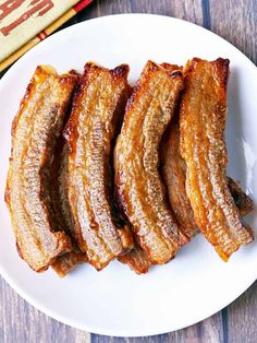 pork belly slices on a white plate with text overlay that reads pork belly slices