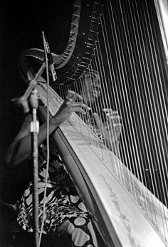 a woman is playing the harp with her hands