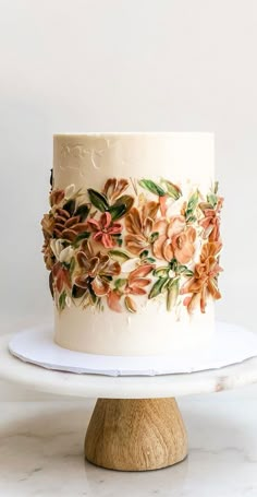 a white cake with flowers painted on it