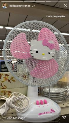 a hello kitty fan sitting on top of a table