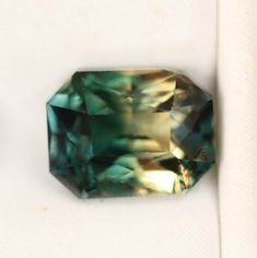 two green diamonds sitting on top of a white surface