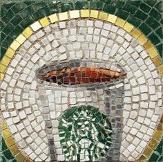 there is a mosaic design on the side of a wall that has a coffee cup in it