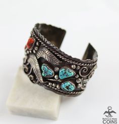 Embrace the essence of the Southwest with our Vintage Native Silver Turquoise & Red Coral Wide Boho Cuff Bracelet. This stunning piece features a beautifully detailed Southwestern motif, crafted with premium silver and adorned with striking turquoise and red coral stones. Elevate your style with this unique and luxurious bracelet. * Weight: 88.6 grams * Measurements: 1.9" width, 2.5" inside width, 1" gap Southwestern Adjustable Multi-stone Cuff Bracelet, Luxurious Bracelet, Turquoise Silver Bracelet, Boho Cuff Bracelet, Boho Cuff, Coral Stone, Fine Jewelry Bracelets, Bracelet Vintage, Vintage Turquoise