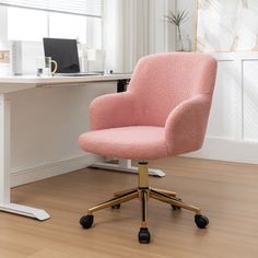 a pink office chair sitting in front of a white desk