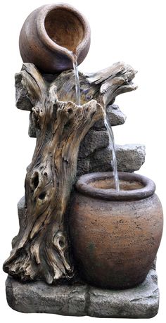 a stone fountain with a pot on top and water pouring out of it's sides