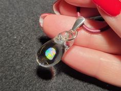 "Dive into the depths of the ocean with my dainty Mermaid's Tears pendant! This gorgeous small hand-blown teardrop pendant is made with only the highest quality borosilicate glass and features a mesmerizing Gilson opal polished nugget that shimmers with blue, green, yellow, orange and even a hint of red within the opal encased in glass. I carefully hand blow each pendant by melting the glass tubing with the Gilson opal inside within a bubble at the end.  I then condense the bubble to a solid form into the  perfect teardrop shape. This must be done slowly to completely encase the  Gilson opal within the glass to create a stunning, one-of-a-kind piece that's truly unique. The tiny boro pendant measures .8\" x .4\"  but with the bail the whole pendant dangles 1.2\".  This petite  pendant come Mystical Teardrop Jewelry For Gifts, Silver Opal Drop Jewelry, Opal Choker, Beach Glam, Art Glass Jewelry, Mermaid Tears, Choker Pendant, Necklace Design, Color Tones