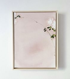 a painting hanging on the wall with flowers painted on it's sides and leaves in the middle