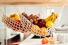 a hammock filled with fruit sitting on top of a kitchen counter