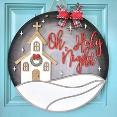 a door hanger that says oh, holly night with a house and wreath on it