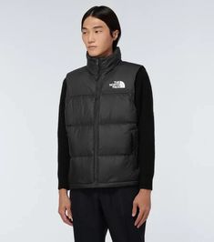 This black nylon vest from The North Face is filled with warm feather-down, features an embroidered logo at the chest and back and comes with a packaway hood..Filling: 90% down, 10% feathers.Contains non-textile parts of animal origin.Designer color name: R Tnf Black.Care instructions: machine wash at 40 degrees.Lining: 100% polyamide, fully lined.Closure: zipped front.Material: 100% nylon.Pockets: zipped pockets.True to size.Straight fit.Thick material.Non-stretchy fabric.Falls to the hip.The model in the picture is 185cm-6'1' and wearing a size M Casual The North Face Nylon Puffer Jacket, Casual Nylon Puffer Jacket By The North Face, Black Vest For Hiking In Fall, Black Nylon Puffer Jacket By The North Face, Black The North Face Sporty Puffer Jacket, Black Sporty The North Face Puffer Jacket, Black Sporty Puffer Jacket By The North Face, Black Hiking Vest Outerwear, Black Sporty Puffer Vest