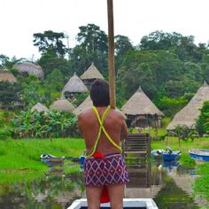 a man standing on top of a boat in the water