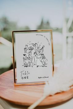 a greeting card sitting on top of a wooden table next to a white fluffy ball