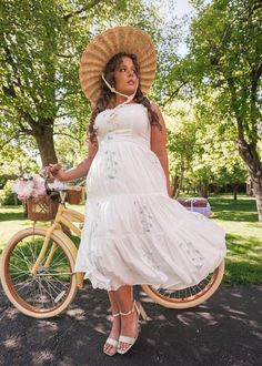 Carefree And Happy Embrace the serene beauty of the outdoors with our Summer Meadow Dress. This enchanting white dress features delicate blue floral embroidery and a tiered skirt that flows gracefully with every step. The fitted bodice and charming bow detail at the neckline add a touch of romantic elegance, making it perfect for picnics and sunny afternoon strolls. Complete with a wide-brimmed hat and a vintage bicycle, the Summer Meadow Dress captures the essence of idyllic summer days. Ruffle White Tiered Dress With Floral Embroidery, White Dress With Floral Embroidery And Tiered Skirt, Meadow Dress, Summer Meadow, Vintage Bicycle, Brimmed Hat, Sunny Afternoon, Wide Brimmed Hats, Tiered Skirt