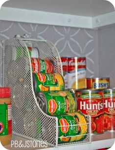 canned food is stored in a metal container on the shelf next to other canned foods