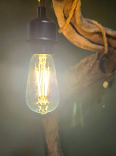 an old fashioned light bulb hanging from a wall