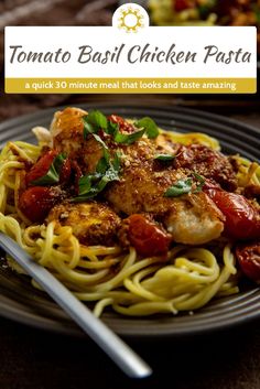 a plate of pasta with chicken, tomatoes and basil on it next to a fork