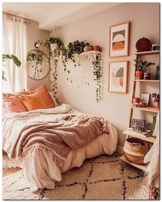 a bedroom with lots of plants and pictures on the wall above the bed, along with hanging planters