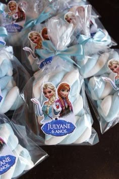 frozen princess cookies wrapped in cellophane and sitting on top of each other for sale