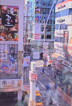 a city street filled with lots of traffic and people walking on the side of it