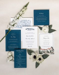 the wedding stationery was done in navy blue and white, with flowers on each side