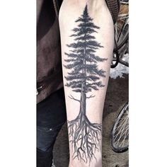 a man with a tree tattoo on his arm