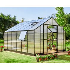 a small greenhouse in the middle of a yard