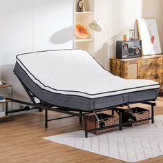 a mattress is sitting on top of a bed frame in a room with hardwood floors