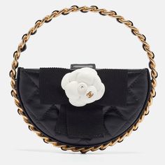 CHANEL Black Quilted Leather Mini Round Camellia ClutchThe Chanel clutch is a stunning accessory crafted from luxurious quilted leather. Its compact, round design features the iconic Camellia motif, offering a chic blend of classic style and modern flair. Ideal for any occasion, this clutch exudes timeless beauty. Size: Height: 9 cm, Width: 2 cm, Length: 15 cmMaterial: LeatherThis item has been used and may have some minor flaws. Before purchasing, please refer to the images for the exact condition of the item. Channel Handbags, Chanel Clutch, Versace Bags, Round Design, Black Quilt, Chanel Black, Quilted Leather, Leather Mini, Dior Bag