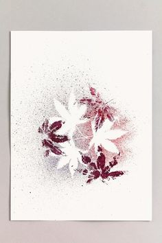 a white paper with red and black flowers on it